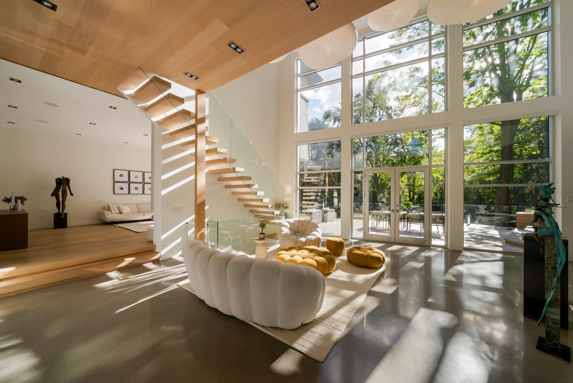 Sunlit living room and floating staircase